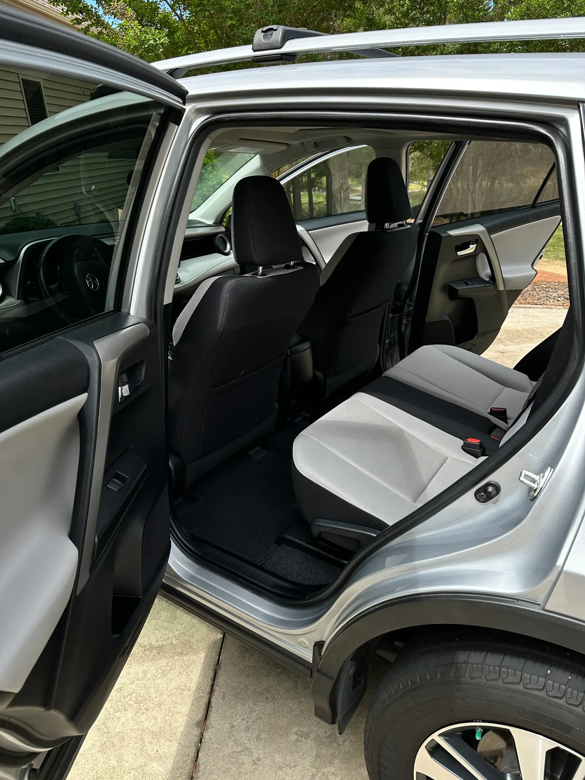Silver SUV rear door open after interior detail — clean gray fabric back seat Pinehurst NC