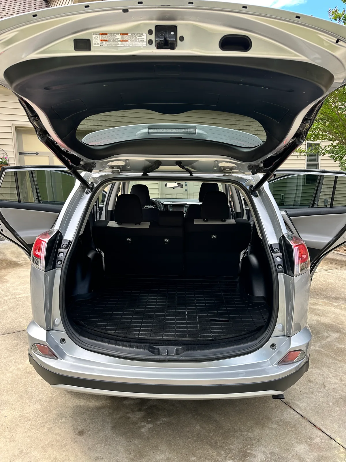 Silver SUV door panel and seat after interior detail — deep cleaned fabric