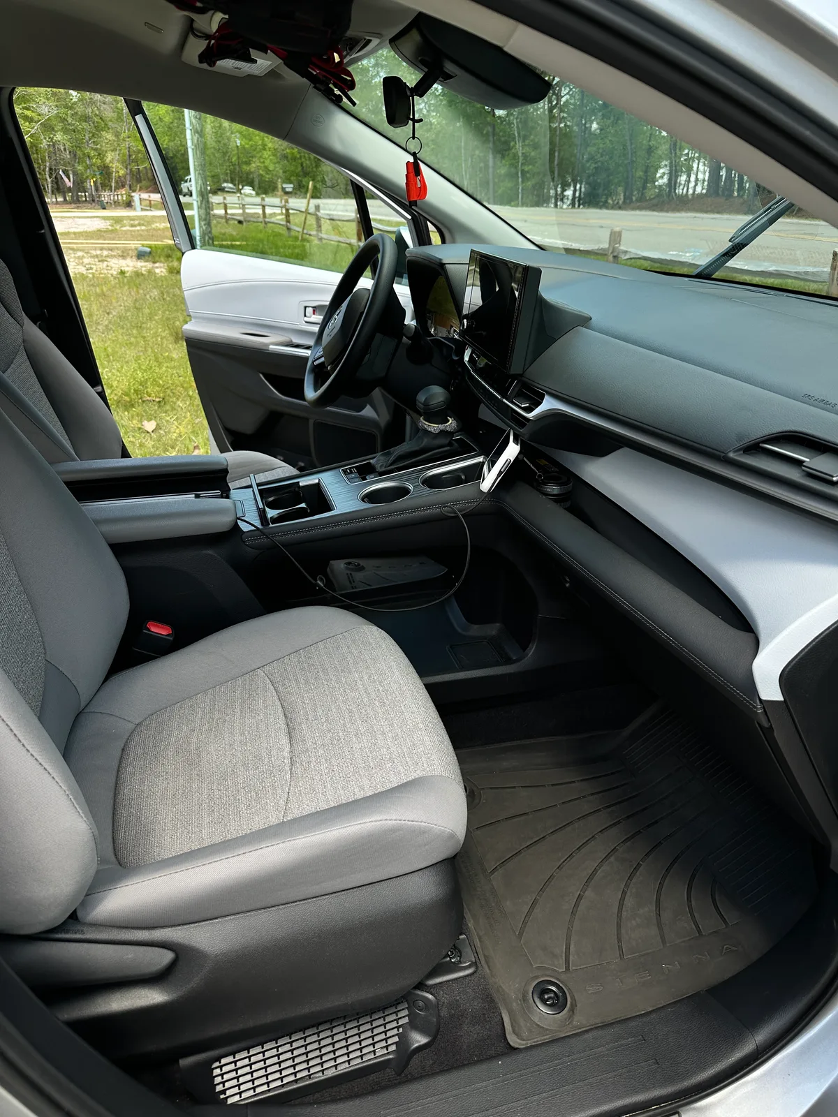 Family SUV third row floor after interior detail — clean rubber mat and carpet