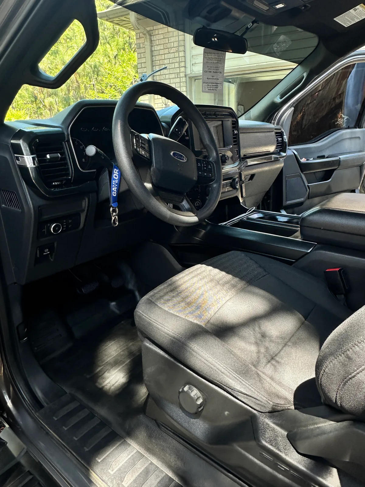 Dark SUV rear door open after interior detail — spotless carpet and door panel