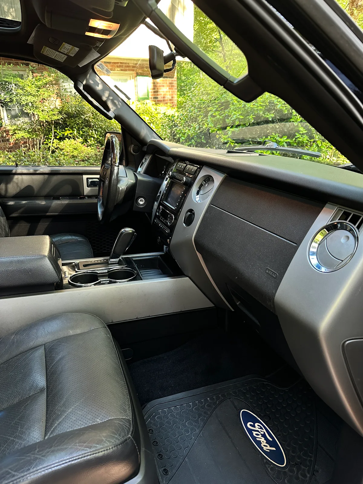 Ford truck interior after detail — clean black leather seats and center console Pinehurst NC
