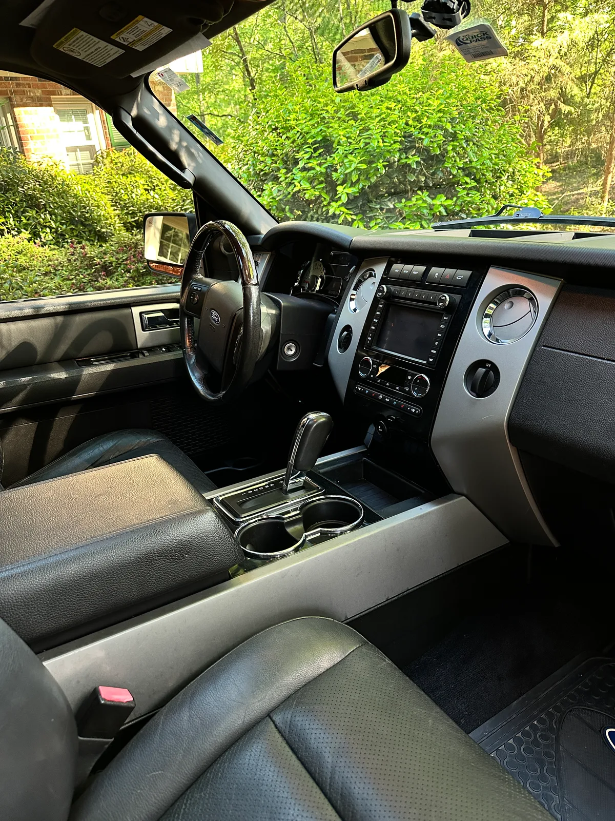 Ford truck dashboard and steering column after interior detail — deep cleaned black leather