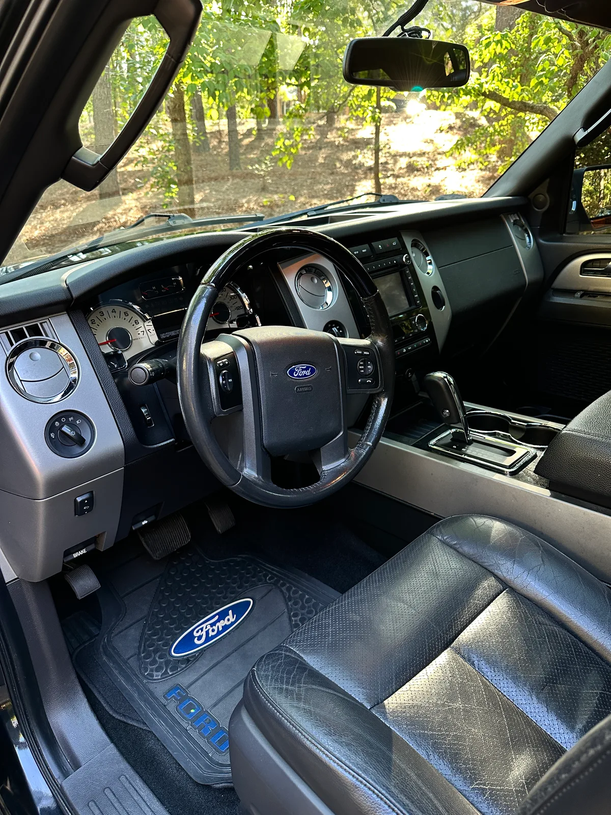 Ford truck overhead console after detail — clean headliner buttons and sun visors