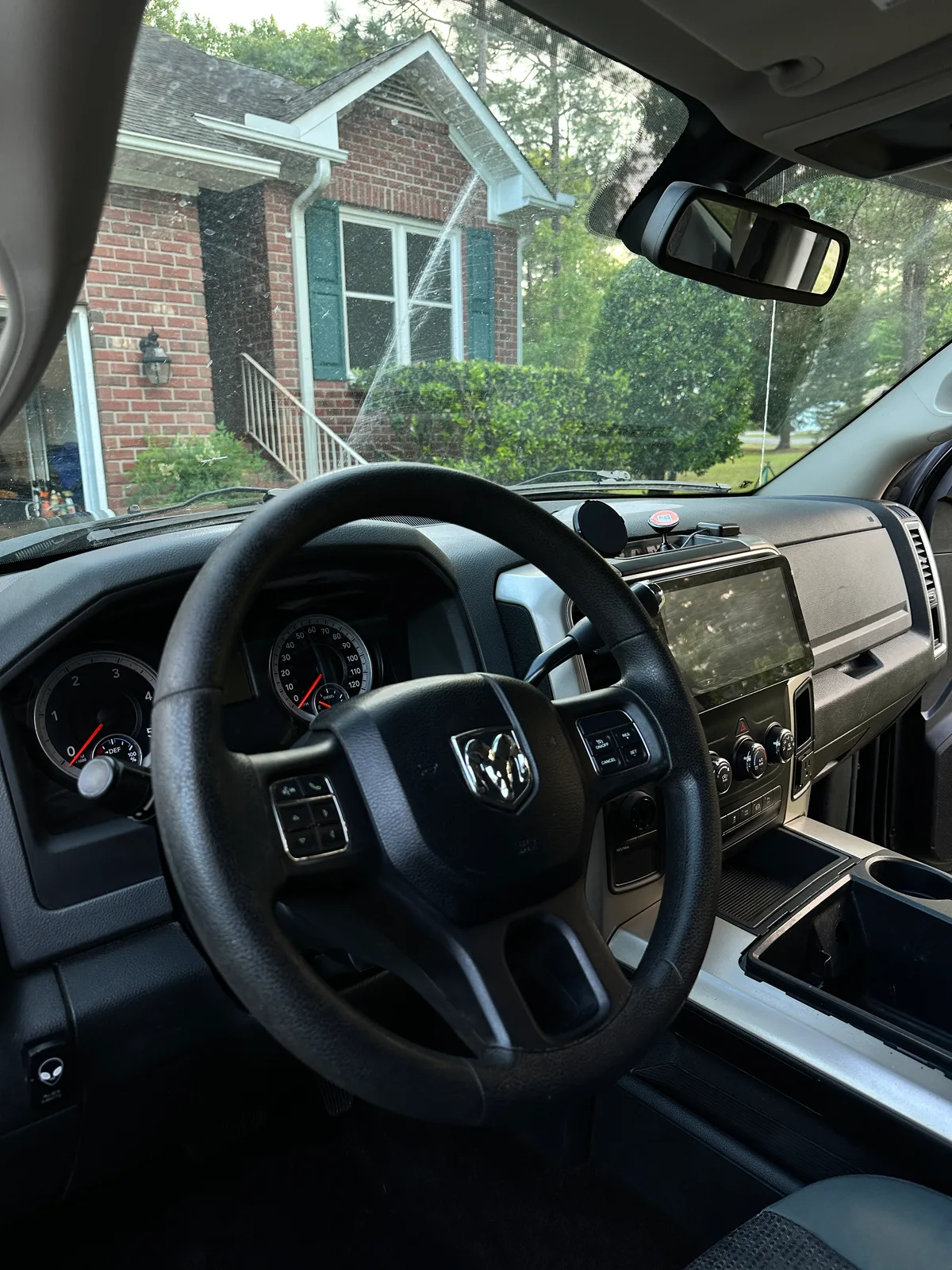 Ram truck front seats after interior detail — spotless gray fabric and center console