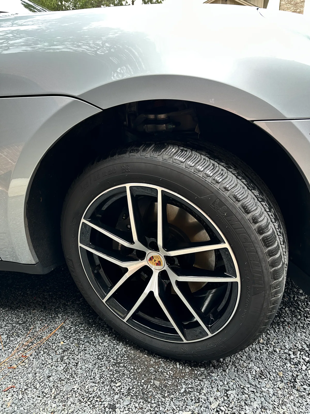 Silver Porsche side profile after exterior detail — clean paint and door panels