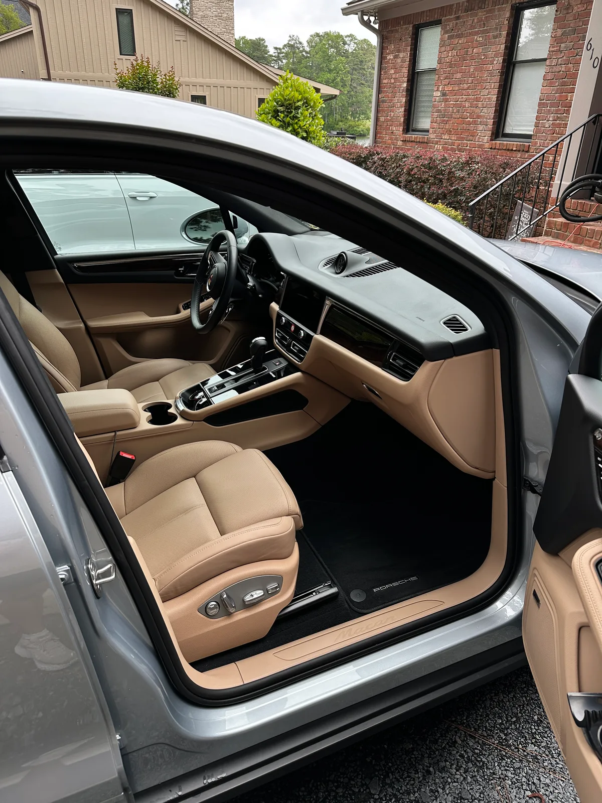 Porsche wheel arch after exterior detail — spotless rim and tire dressing