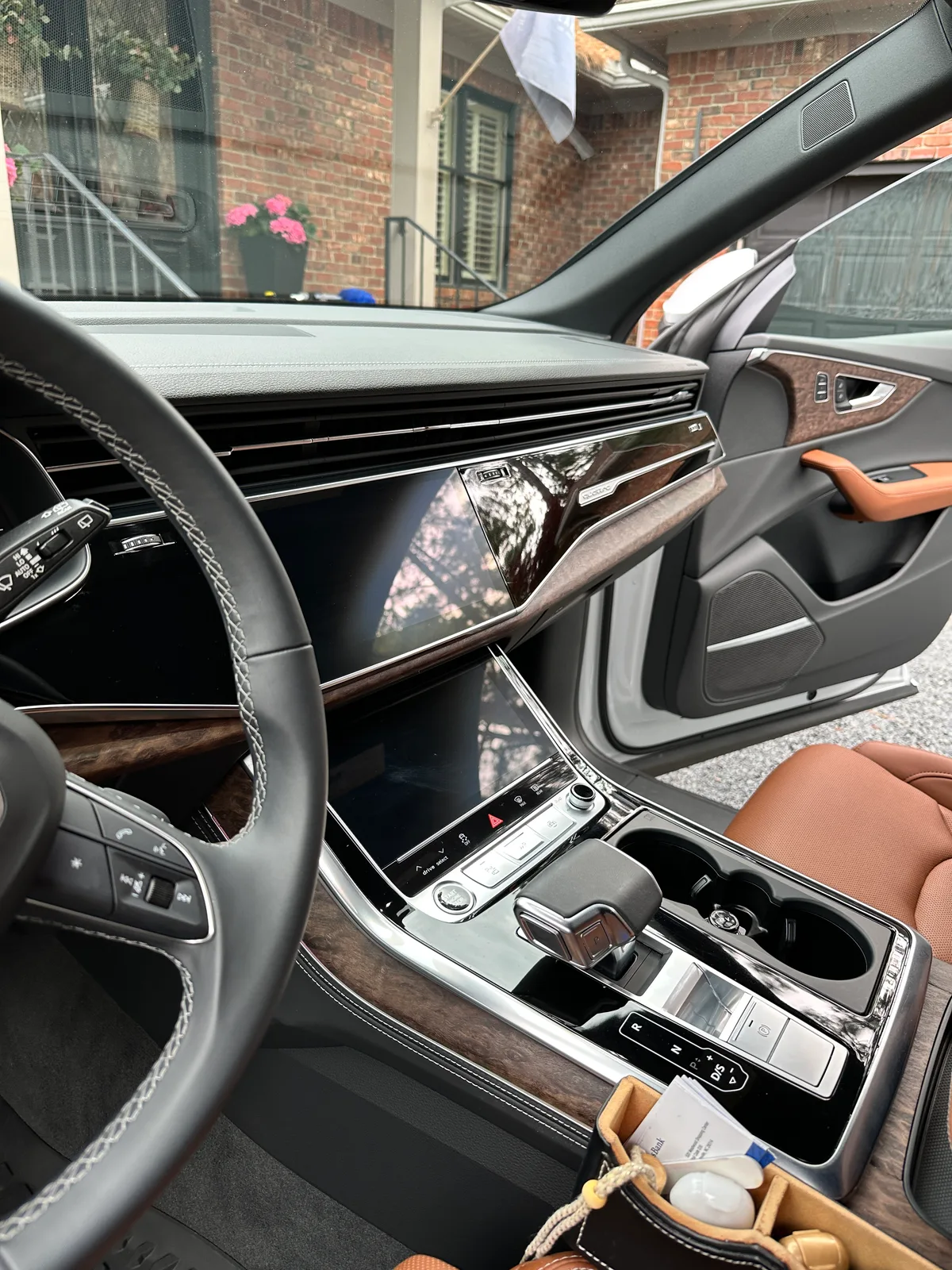 White luxury SUV door sill and seat edge after detail — clean leather stitching