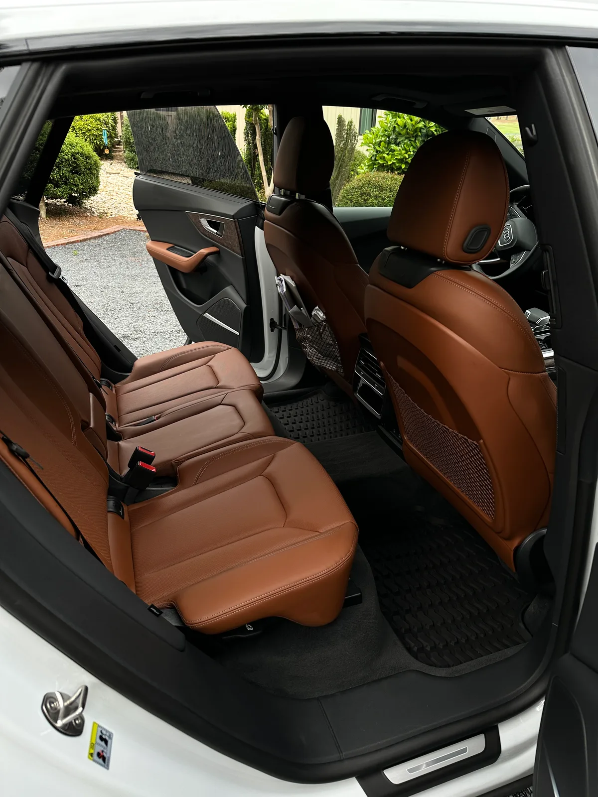 White luxury SUV floor area after interior detail — clean tan carpet and mat