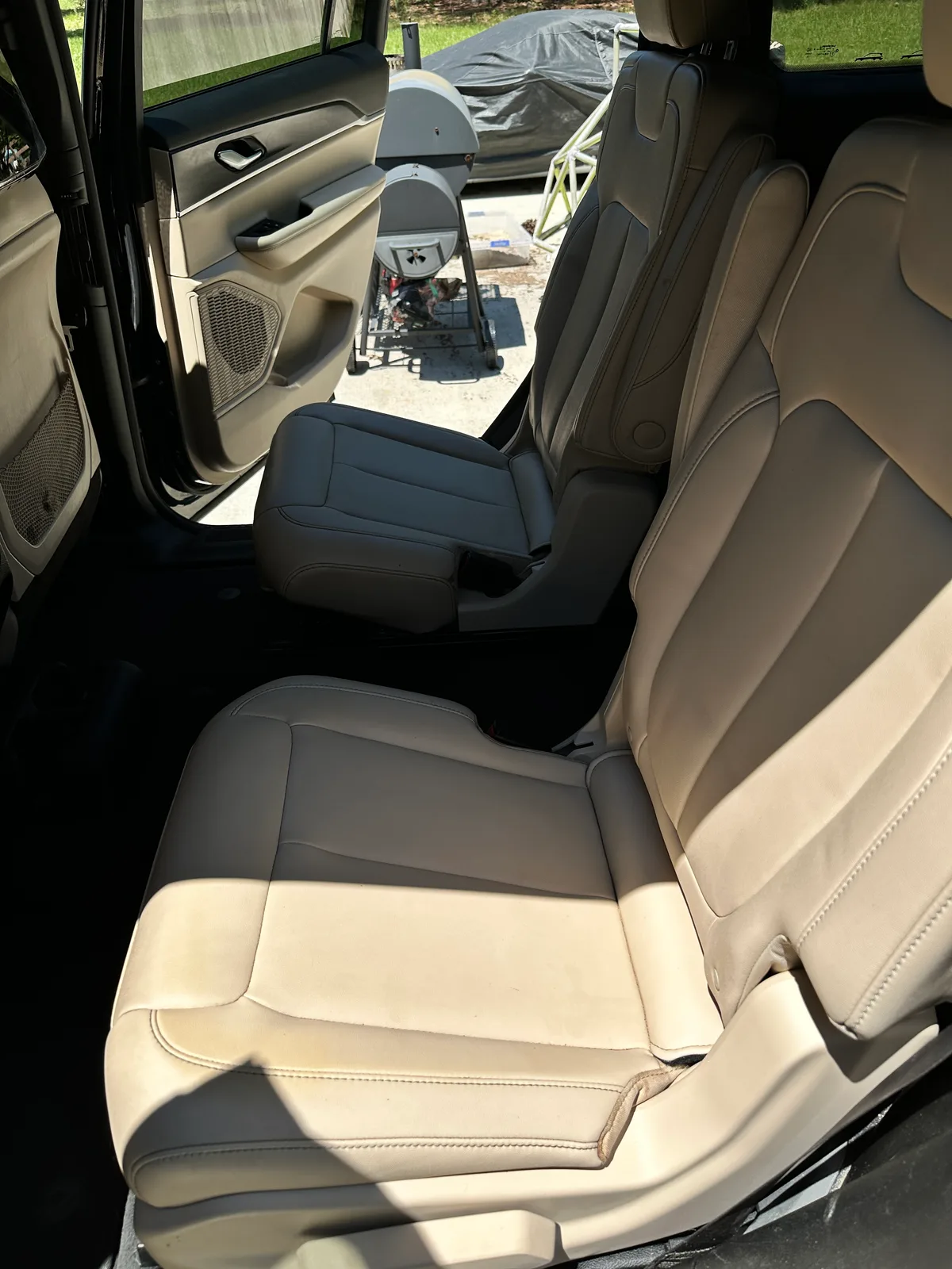 Luxury SUV interior after detail — spotless cream leather door panel and armrest