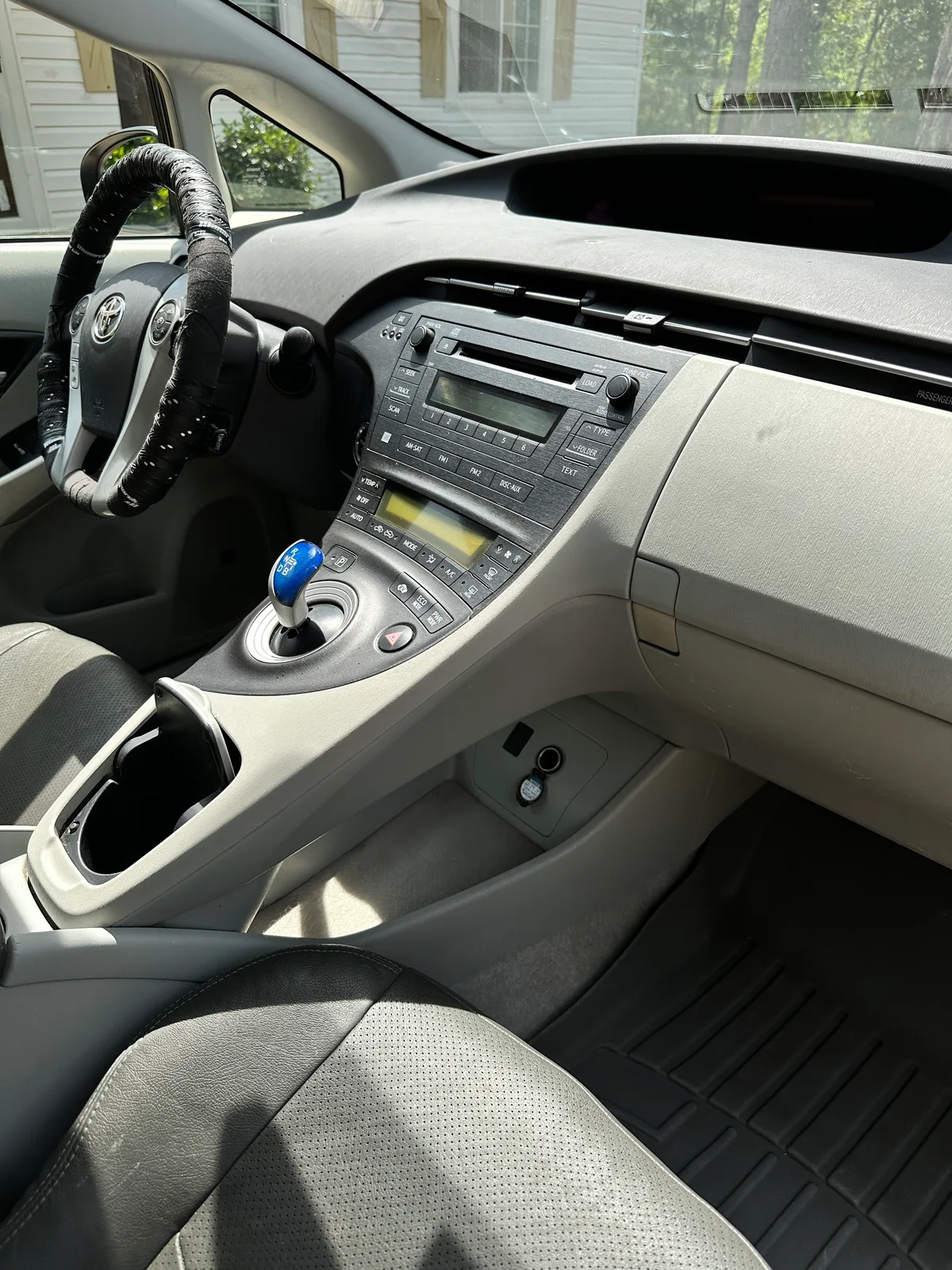 Toyota interior after detail — deep cleaned door panel and floor mat
