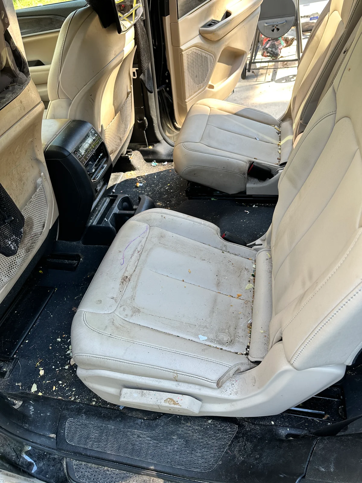 SUV interior before detail — dirty stained tan leather