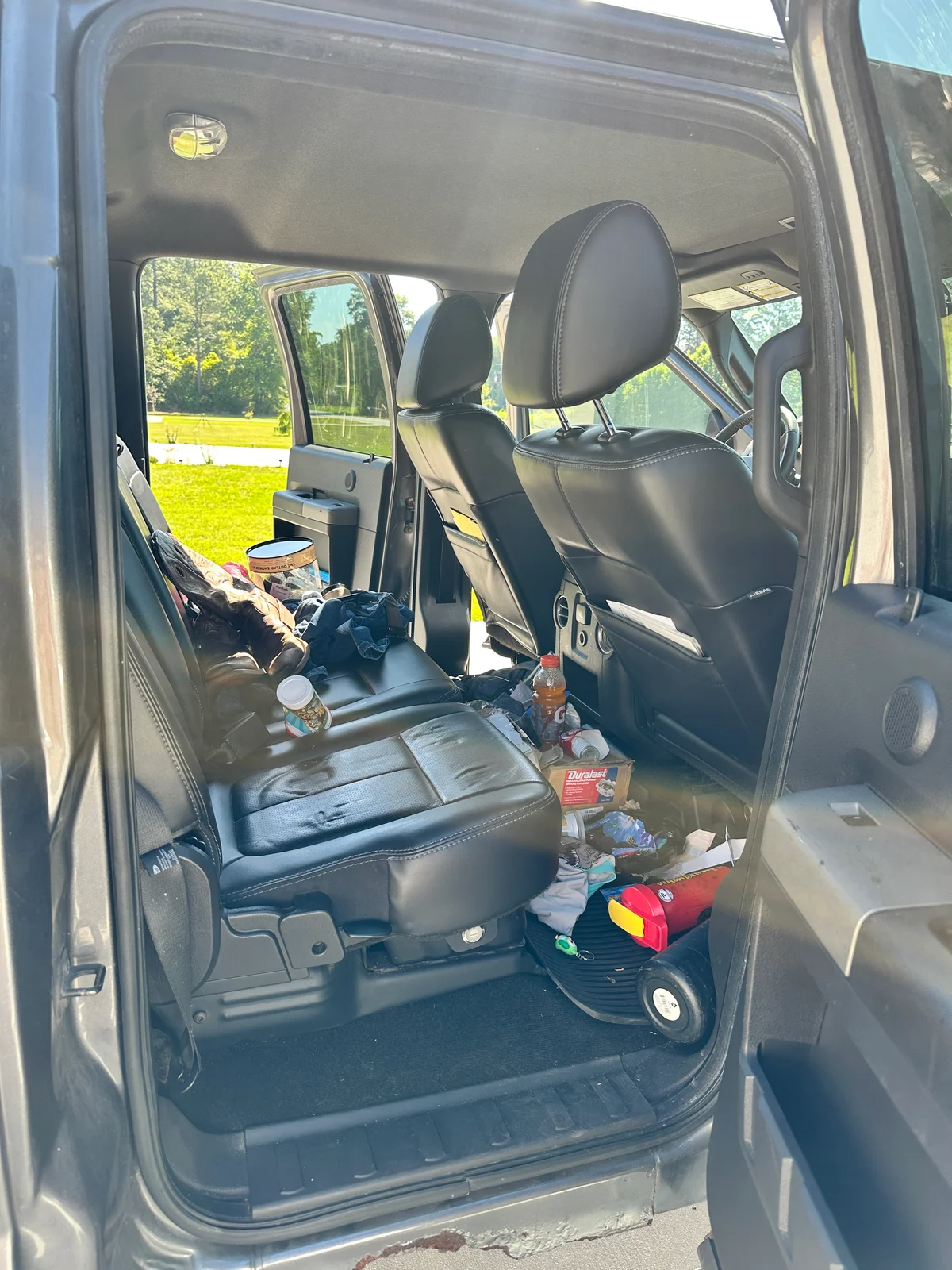 Truck interior before detail — trash and debris on seats